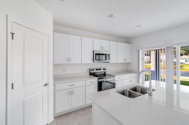 349 River Front Way, Edgewater, FL 32141 - kitchen featuring sink, a textured ceiling, white cabinets, and appliances with stainless steel finishes
