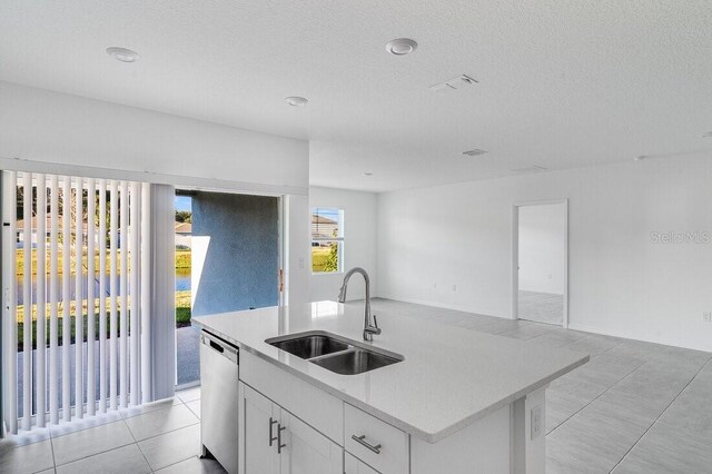 349 River Front Way, Edgewater, FL 32141 - kitchen featuring sink, light tile patterned floors, dishwasher, a kitchen island with sink, and white cabinets