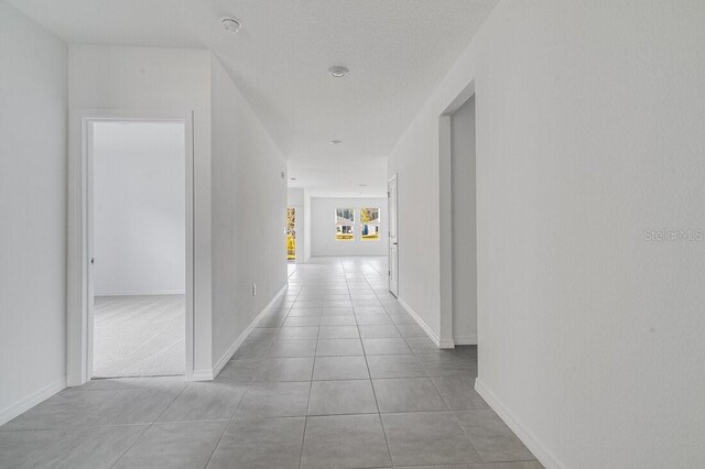 349 River Front Way, Edgewater, FL 32141 - corridor featuring light tile patterned flooring and a textured ceiling