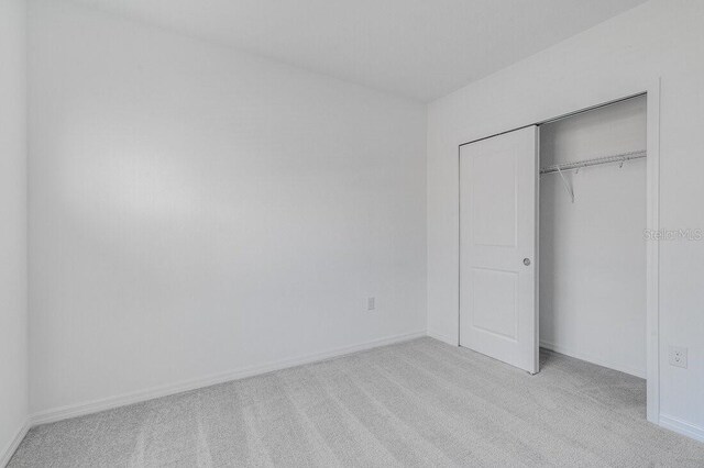 349 River Front Way, Edgewater, FL 32141 - unfurnished bedroom featuring light carpet and a closet