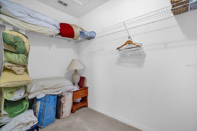 walk in closet with carpet floors