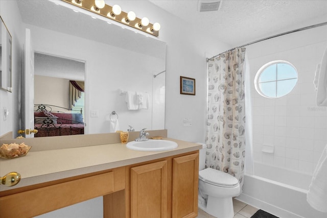 full bathroom with a textured ceiling, tile patterned flooring, vanity, shower / bath combo, and toilet