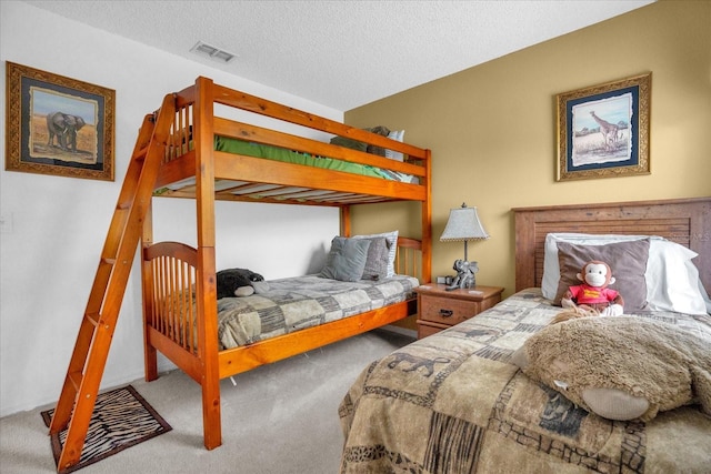 bedroom featuring a textured ceiling and carpet floors