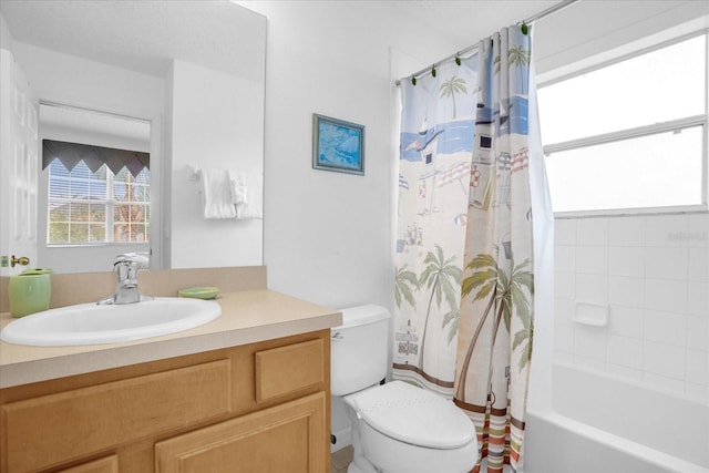 full bathroom featuring toilet, shower / bathtub combination with curtain, and vanity