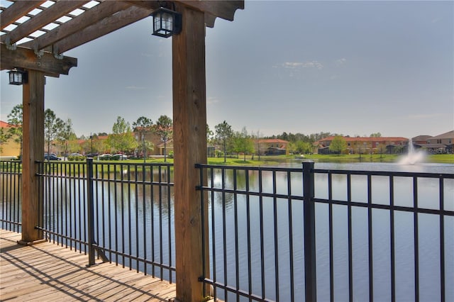 balcony with a pergola and a water view