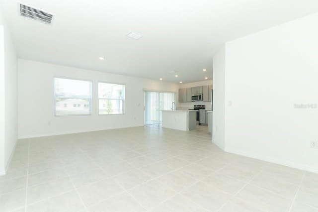 unfurnished living room featuring light tile patterned flooring