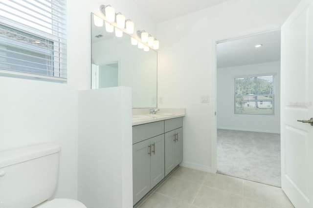 bathroom featuring tile patterned floors, vanity, and toilet