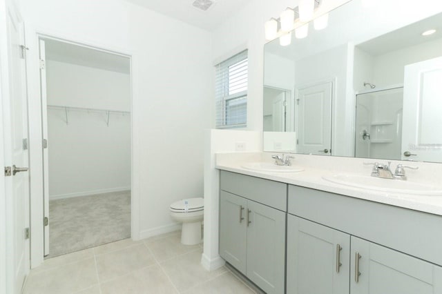 bathroom featuring walk in shower, tile patterned flooring, vanity, and toilet