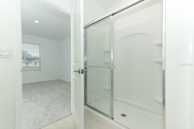 bathroom featuring a shower with shower door