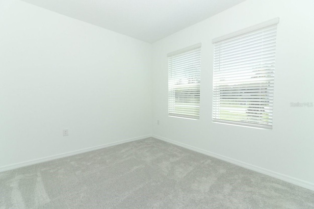 unfurnished room with light carpet