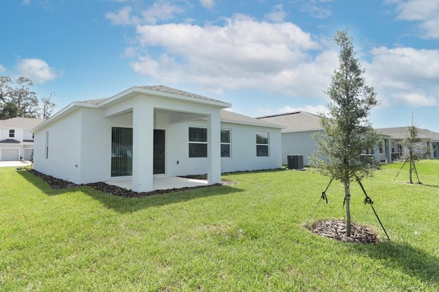 back of house with central AC, a patio area, and a yard