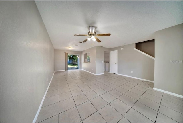 tiled empty room with a textured ceiling and ceiling fan