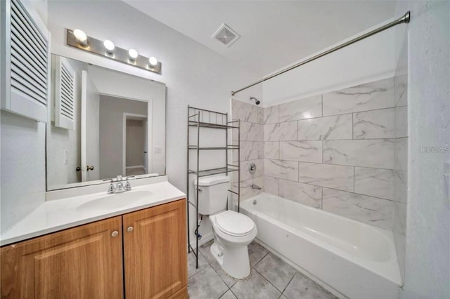 full bathroom featuring vanity, tiled shower / bath combo, toilet, and tile patterned flooring