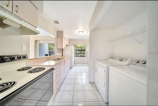 laundry room featuring light tile patterned floors and sink