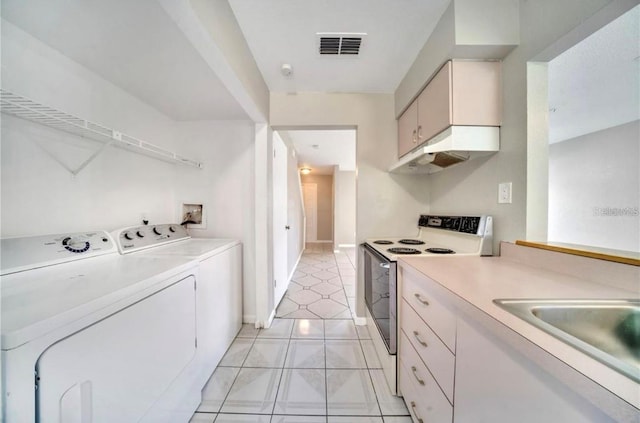 interior space featuring light tile patterned floors, separate washer and dryer, and sink