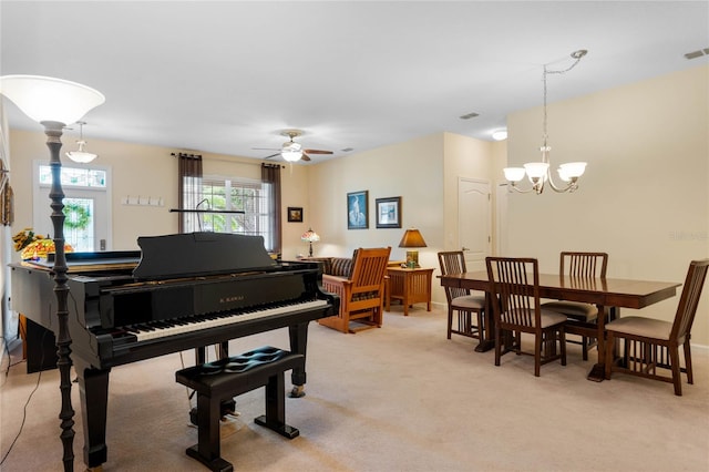 miscellaneous room with ceiling fan with notable chandelier and light carpet