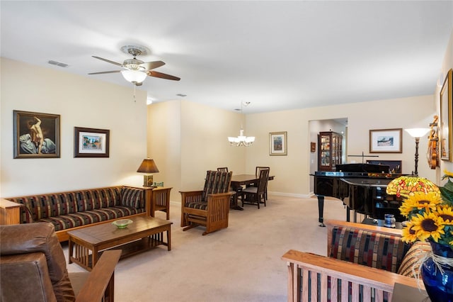 living room featuring ceiling fan with notable chandelier and light colored carpet