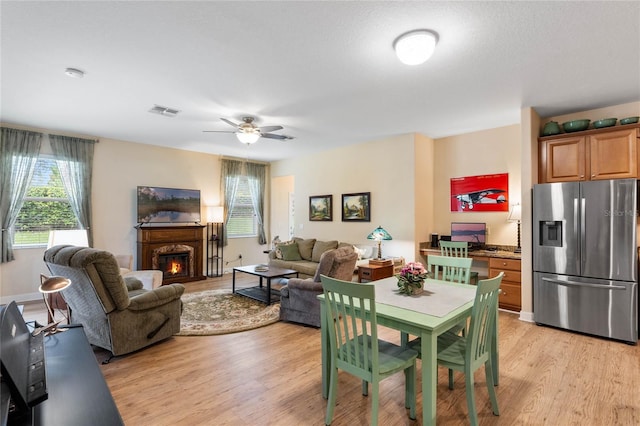 interior space with ceiling fan and light hardwood / wood-style floors