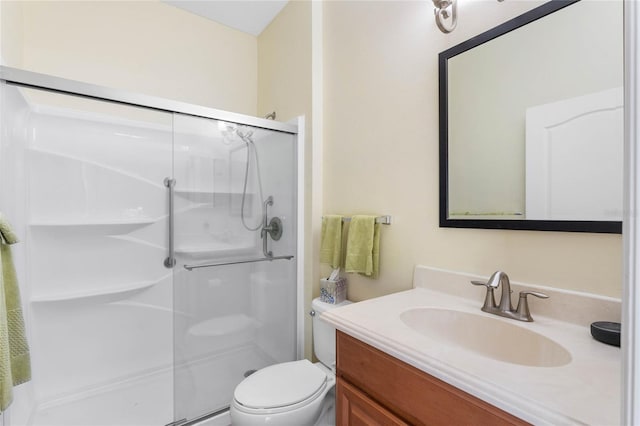 bathroom featuring walk in shower, toilet, and vanity