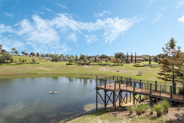 dock area with a lawn and a deck with water view