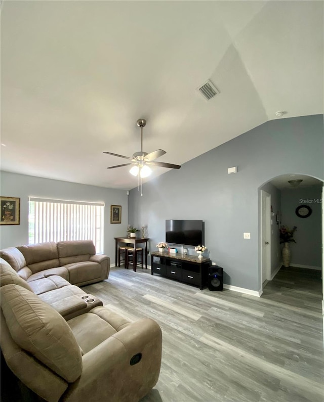 living room with ceiling fan, lofted ceiling, and hardwood / wood-style flooring