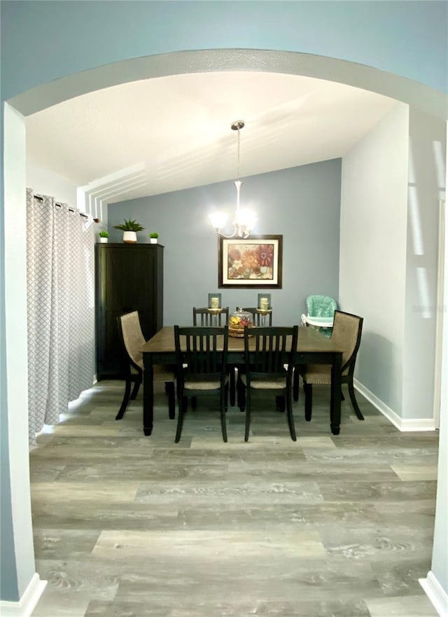 dining area with a notable chandelier and wood-type flooring