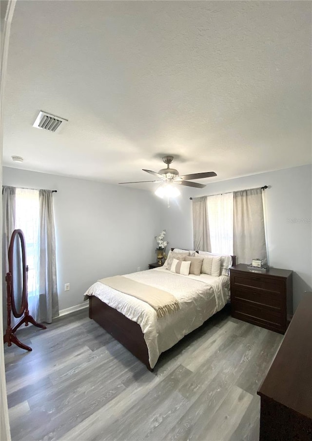 bedroom with ceiling fan and hardwood / wood-style flooring