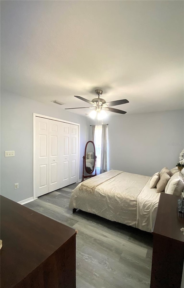 bedroom featuring ceiling fan, a closet, and hardwood / wood-style floors