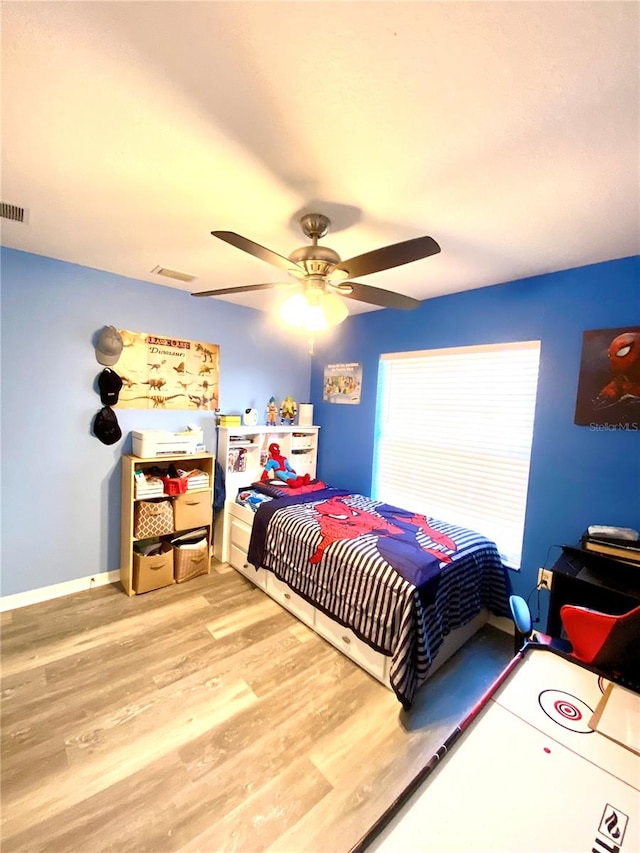 bedroom with ceiling fan and light hardwood / wood-style floors