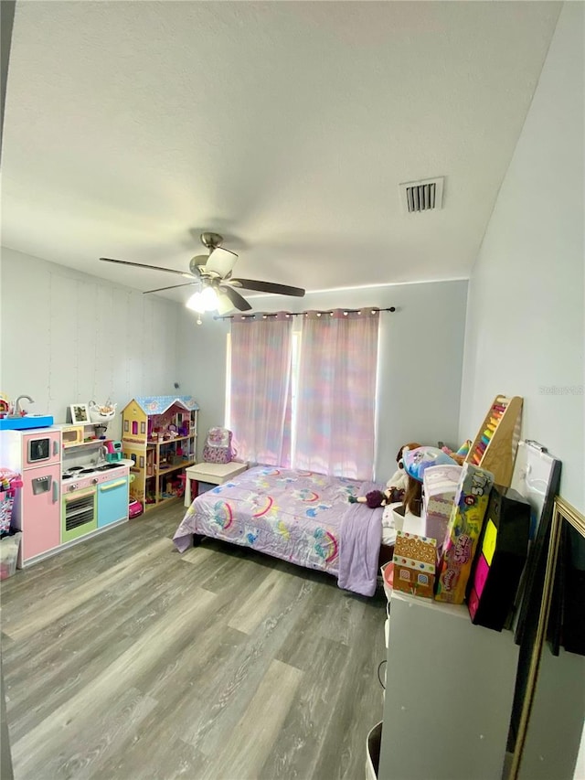 bedroom with ceiling fan and hardwood / wood-style flooring