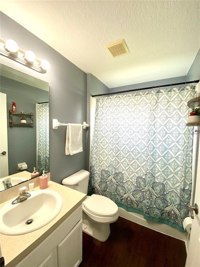 bathroom with vanity, a textured ceiling, toilet, and hardwood / wood-style flooring