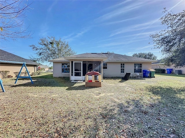 4490 Treasure Cay Rd, Tavares, FL 32778 - rear view of property with a sunroom, stucco siding, a yard, and central AC