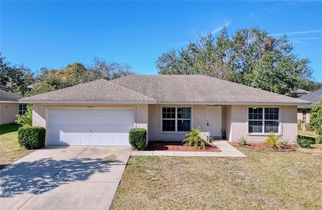 ranch-style house featuring a garage and a front lawn