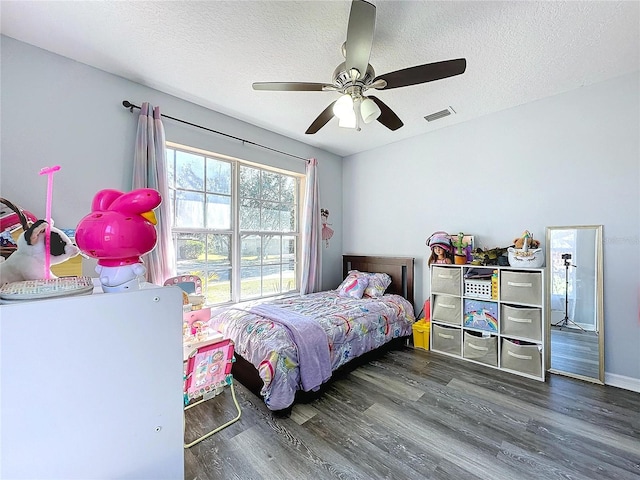 4490 Treasure Cay Rd, Tavares, FL 32778 - bedroom featuring wood finished floors, a textured ceiling, and a ceiling fan