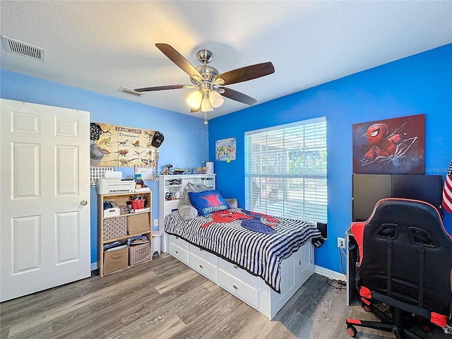4490 Treasure Cay Rd, Tavares, FL 32778 - bedroom with wood finished floors, a ceiling fan, and baseboards