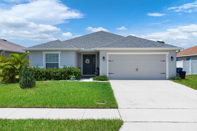 view of front of house with a garage and a front yard