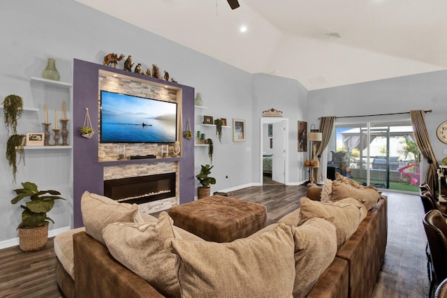 living room featuring lofted ceiling, dark hardwood / wood-style flooring, a fireplace, and ceiling fan