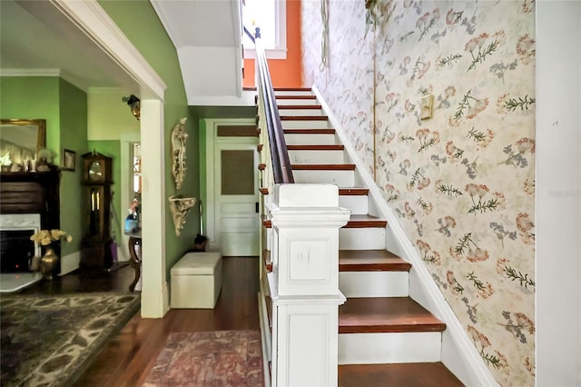 staircase with hardwood / wood-style floors and ornamental molding