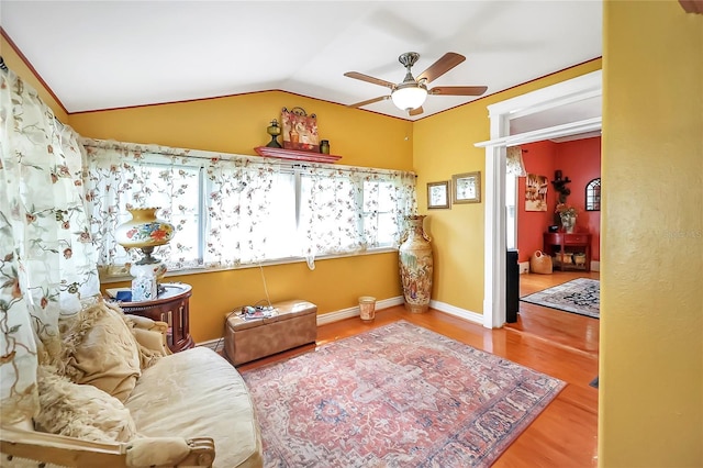 sitting room featuring ceiling fan, wood-type flooring, and lofted ceiling