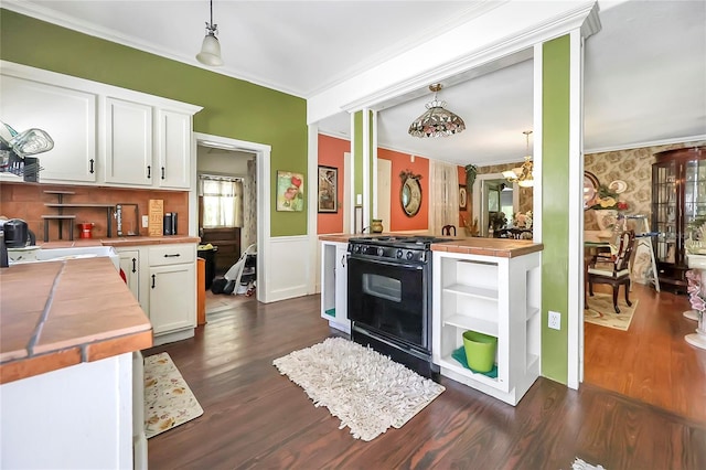 kitchen with dark hardwood / wood-style flooring, white cabinetry, pendant lighting, and black range with gas stovetop