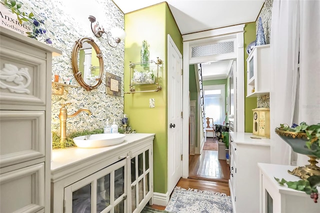 interior space featuring hardwood / wood-style floors, crown molding, and vanity