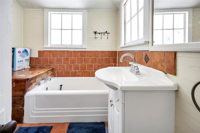 bathroom featuring a tub and vanity