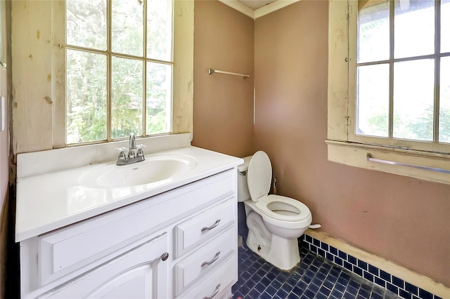 bathroom featuring tile patterned flooring, toilet, and vanity