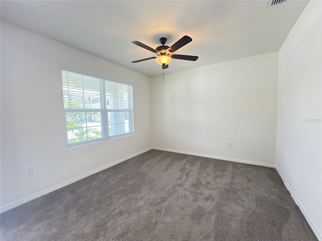 spare room featuring ceiling fan and carpet floors