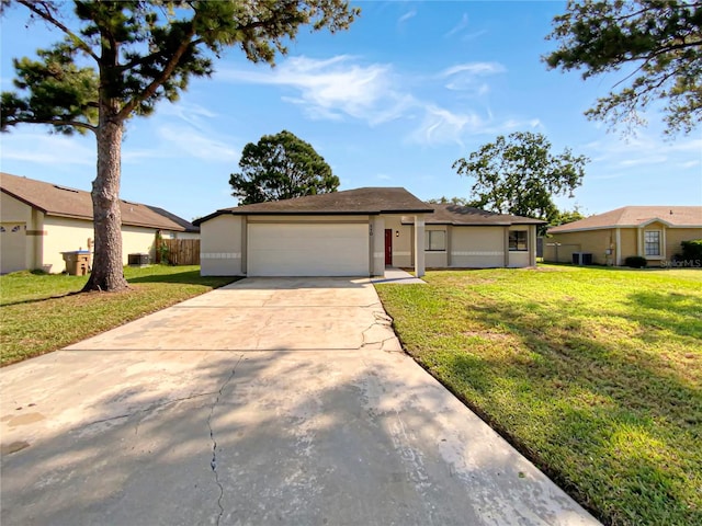 single story home featuring a front lawn and a garage