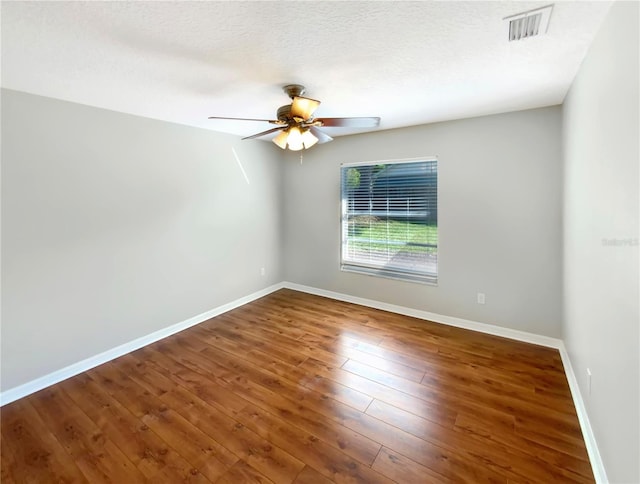 spare room featuring ceiling fan, a textured ceiling, and wood-type flooring