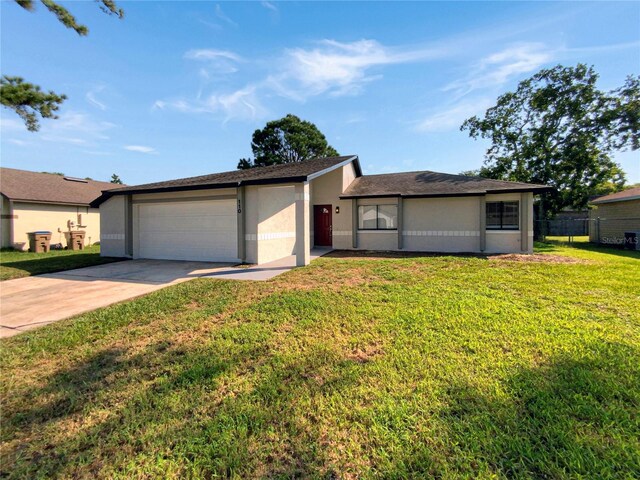 single story home with a front lawn and a garage