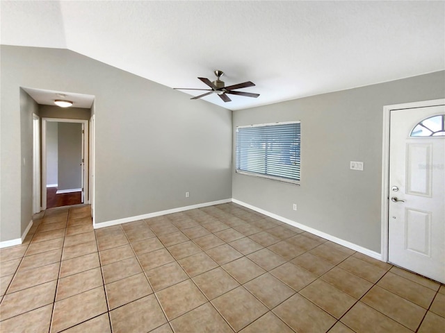 entrance foyer with ceiling fan, vaulted ceiling, and tile patterned flooring