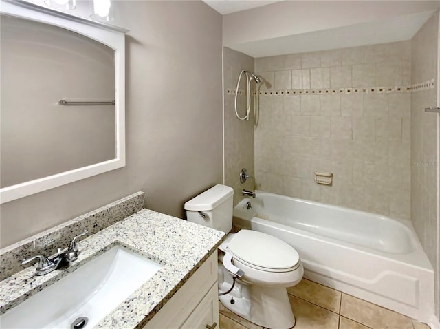 full bathroom featuring vanity, tiled shower / bath, tile patterned flooring, and toilet