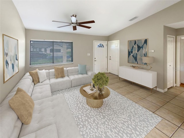 living room featuring ceiling fan, lofted ceiling, and light tile patterned floors